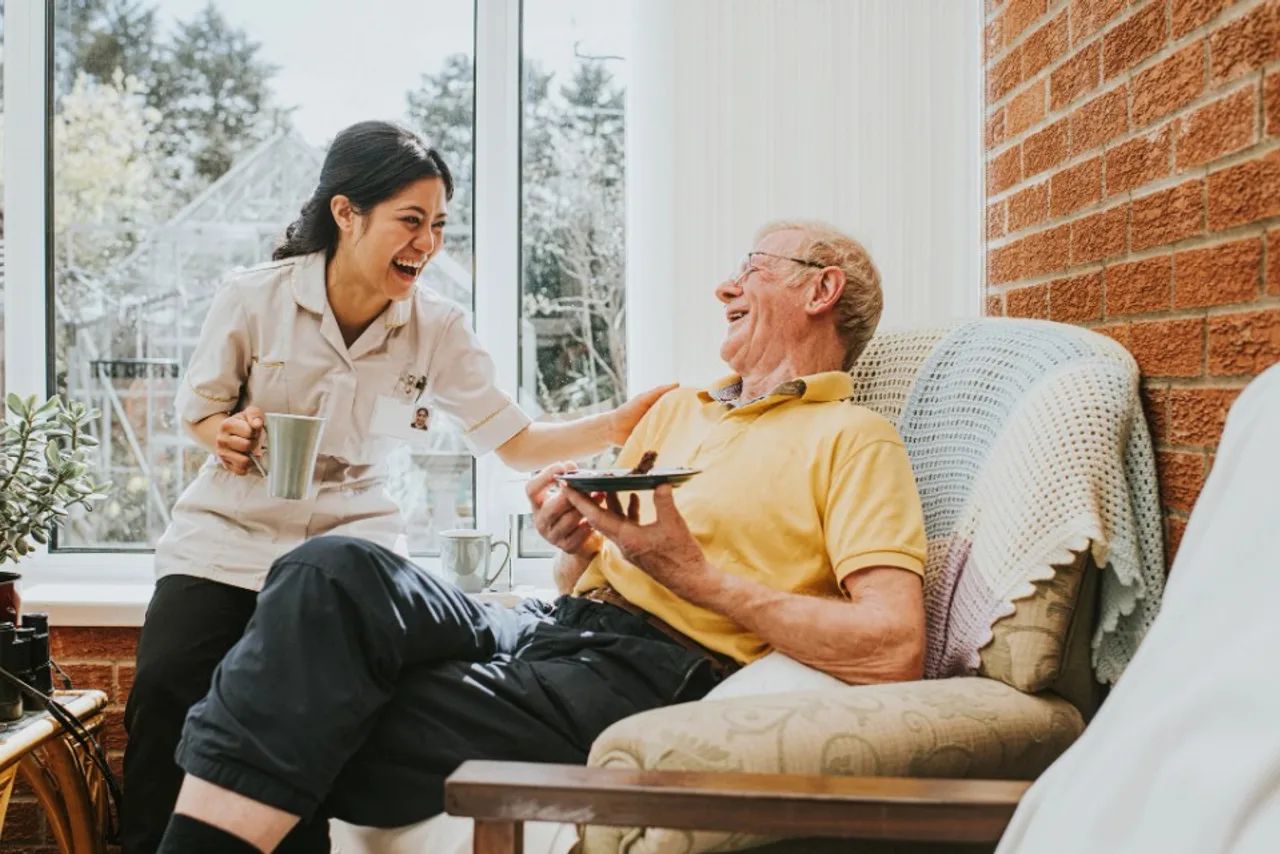 Care professional sharing a moment with an older adult at home — compassionate senior care