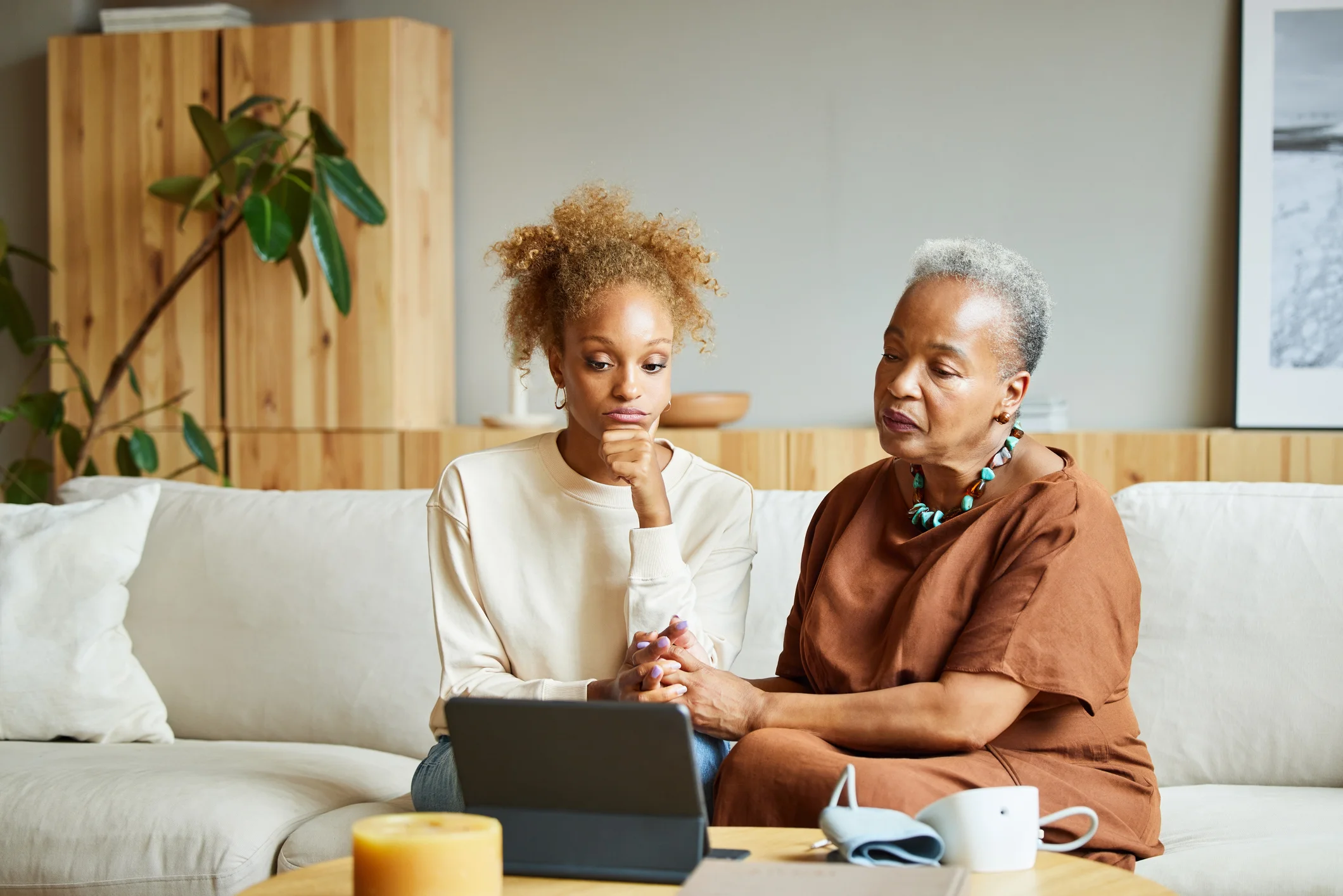 Family researching care facilities together on a laptop