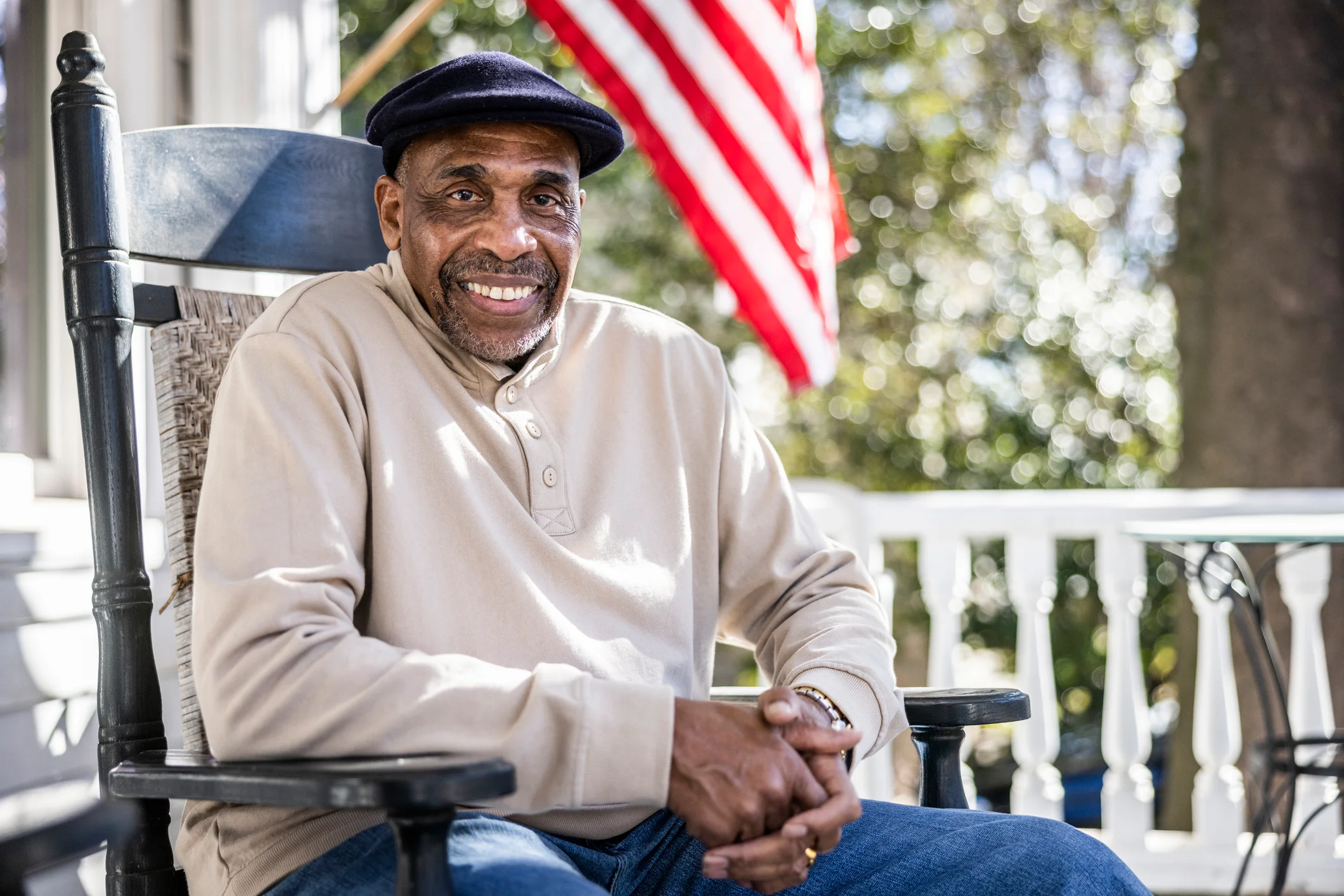 Active senior man smiling on his front porch in an independent living community